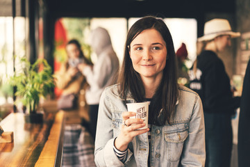 girl in a coffee shop with a cup of coffee