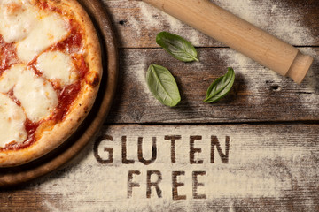 A gluten free pizza on  a rustic wood background