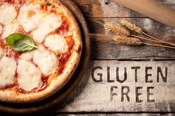 A gluten free pizza on  a rusic wood background