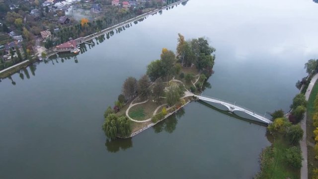Aerial, top view from Drone. A river with beautiful beaches and an island for lovers. The image of the heart on the island. Autumn time.