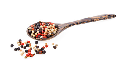dried peppers seeds in wood spoon on white background
