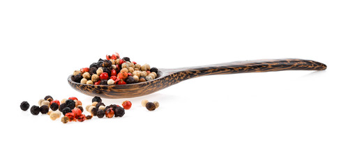 dried peppers seeds in wood spoon on white background