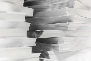 Multiple stacks of A4 sheets of paper organised in to perfect amounts. 