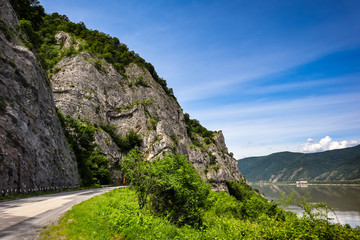 Road by the Danube river, forests and mountains in Djerdap gorge national park in Serbia