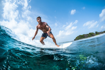 Surfer rides the tropical ocean wave