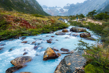 Rapid river with turquise water running along the Valle de Lobos hiking trail in the Argentinean part of the Tierra del Fuego near the city of Ushuaia.