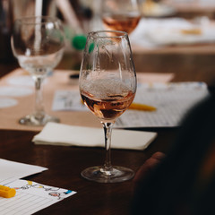 Glass of rose and white wine seen in close hand.