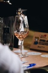 Glass of rose and white wine seen in close hand.
