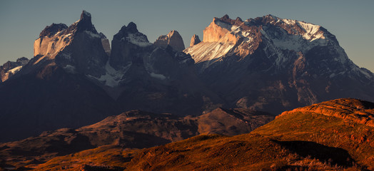 Panoramic shot of the snow and ice capped mountains - Cordillera Paine in Torres del Paine National Park in Chilean Patagonia during sunset