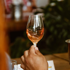 Glass of rose and white wine seen in close hand.
