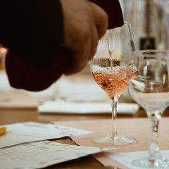 Glass of rose and white wine seen in close hand.