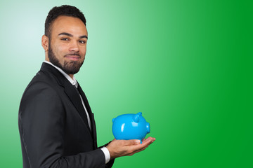 African American business man holding a piggy bank