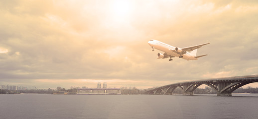Airliner over the river the sun is shining.
