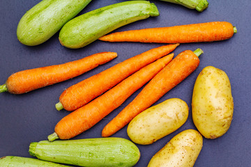 Fresh vegetables cooking black stone background