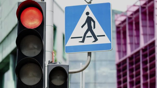 Traffic light and pedestrian crossing sign. Close-up shot on Red camera