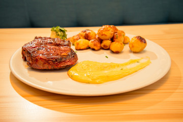 Tasty beef steak with potato and sauce