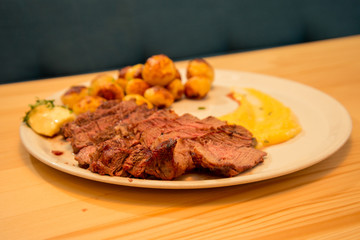 Sliced tasty beef steak with potato and sauce