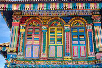 Fototapeta na wymiar Colorful facade architecture building, Vibrant color of wooden windows in Little India district, landmark and popular for tourist attractions in Singapore . Southeast Asia Travel concept