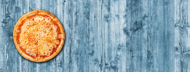 Pizza Margarita sliced top view with copy space. Pizza Margherita on blue wood planks background. Promotional poster or flyer template for pizzerias or restaurants.