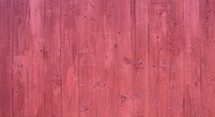 Natural wooden background. Surface of wooden texture for design and decoration. Shabby vertical boards with peeling paint . Crimson color. Copy space.