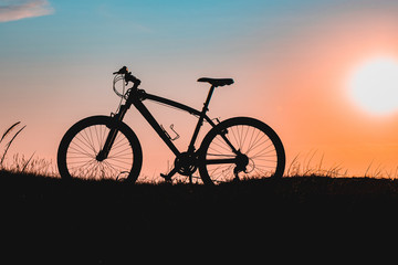Fototapeta na wymiar silhouette of a bicycle at sunset. bike without a man.