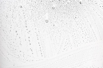 white isolated background water drops on the glass / wet window glass with splashes and drops of water and lime, texture autumn background