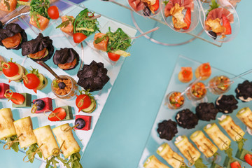 Canapes and light meals, tapas on the table in the restaurant.