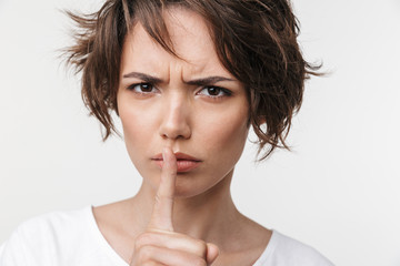 Beautiful young pretty displeased sad woman posing isolated over white wall background showing...