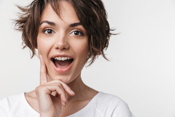 Young pretty excited shocked woman posing isolated over white wall background.