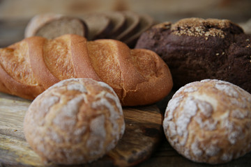  assortment of wheat and rye bread, close-up on a wooden rustic background