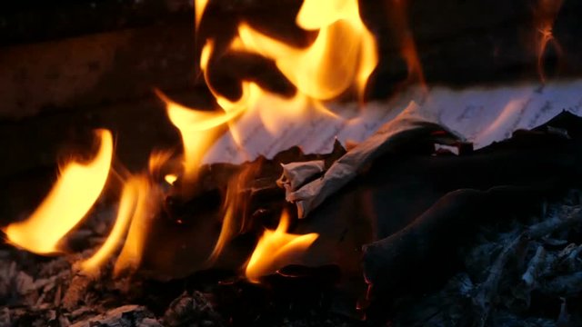 Manuscript pages are burning in fire. Bonfire of Burning Manuscript