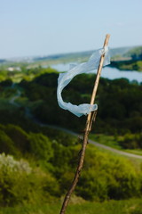 Portrait of plastic bag on a stick as a symbol with beautiful scenery behind it