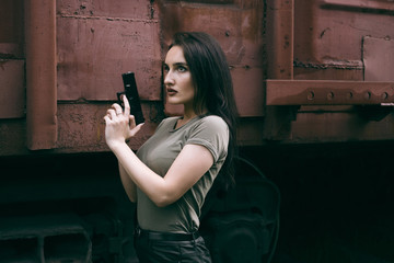 Powerful Woman Holding Gun Action Movie Style. Train adventure. Military girl with .
