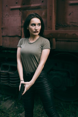 Powerful Woman Holding Gun Action Movie Style. Train adventure. Military girl with .