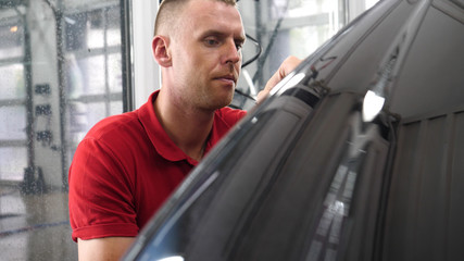 A professional bodywork and headlamp polishing worker will transport the car after painting or...