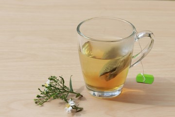 Hot tea in a glass on a wooden table