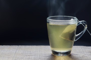 Hot tea in a glass on dark background