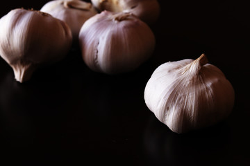 Garlic bulbs on black background
