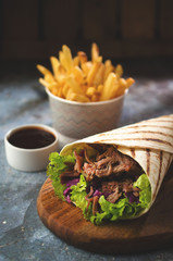 Wrap kebab with vegetables and french fries
