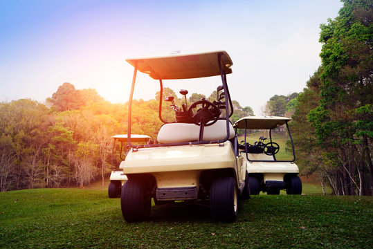 Golf cart on fairway in golf course.
