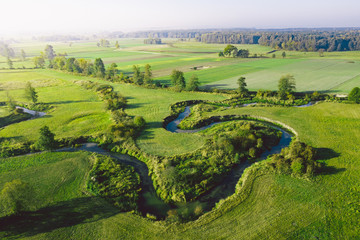 A winding river surrounded by green meadows
