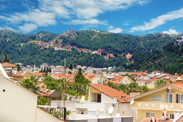 View of Marmaris from above, the roofs of houses from the tiles and the mountains. Turkey