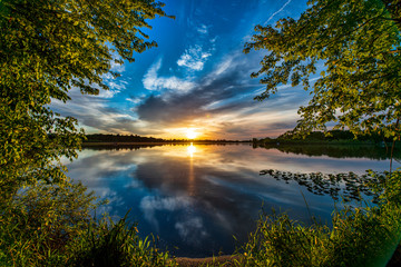 Sunset through the Trees over Quiet Water