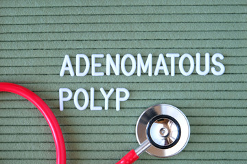 Adenomatous polyp- text from white letters on  green background with  stethoscope, medical concept...