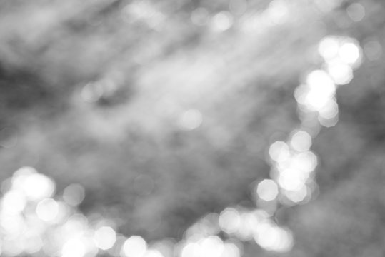 Blurred monochrome background with curved strip of bokeh