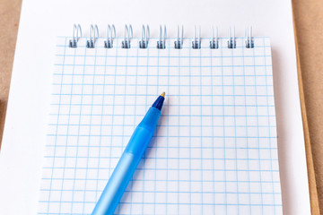 composition with notebook blank page colorful pencil, pen mock-up Back to school concept with stationery office supplies on a brown craft paper background with copy space top view