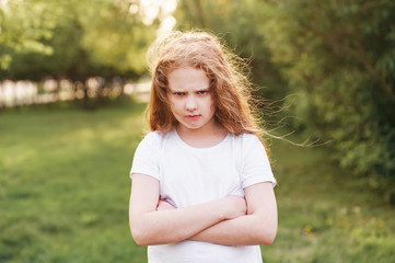 Emotional child with angry expression on face