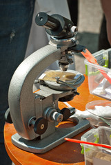 Microscope at a school scientific exhibition. Experiments on chemistry and biology with microscopes. School and student equipment.