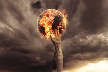 stone hand holding burning earth and rise up in the apocalyptic sky