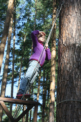 girl stands on a ship in the woods, plays sailor.